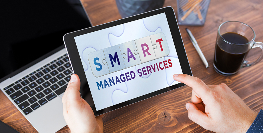Person using tablet viewing SMART Managed Services