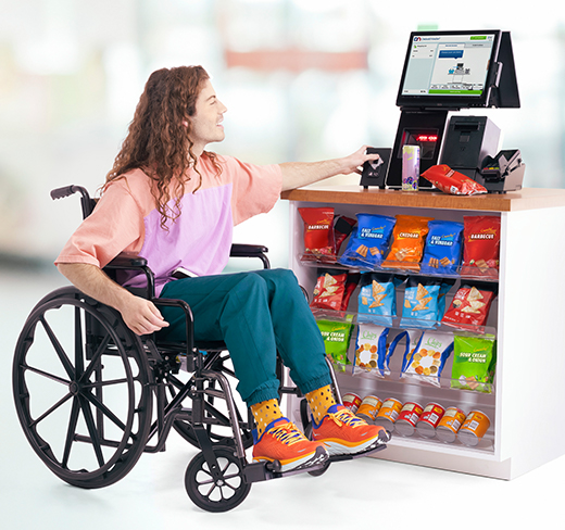 woman in wheelchair using DN Series® Easy One self checkout