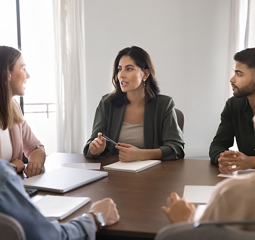 group of people gathered around a table for meeting